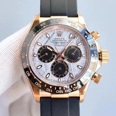 A chronograph wristwatch with a rose gold case, a pale marbled dial, three black sub dials and a black rubber strap